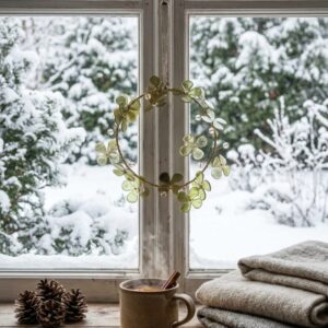 Gold and sage-green floral Christmas wreath with clear bead accents hanging on a window