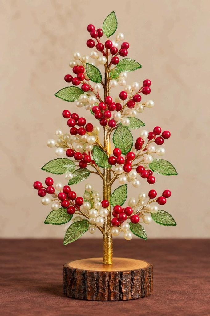 Red berry and pearl beaded Christmas tree with translucent green leaves and rustic wooden base