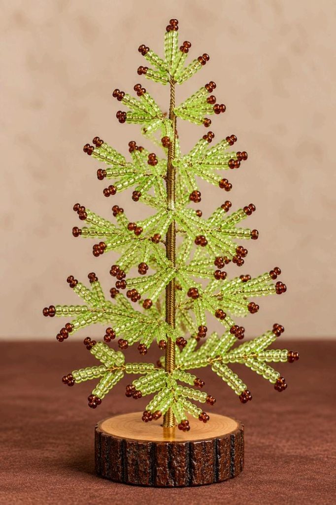 Lime green beaded Christmas tree with brown bead tips, gold-tone stem and rustic wooden base