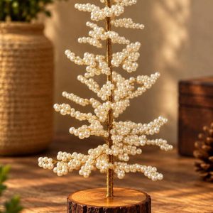 Pearl-white beaded Christmas tree with gold-tone stem and rustic wooden base